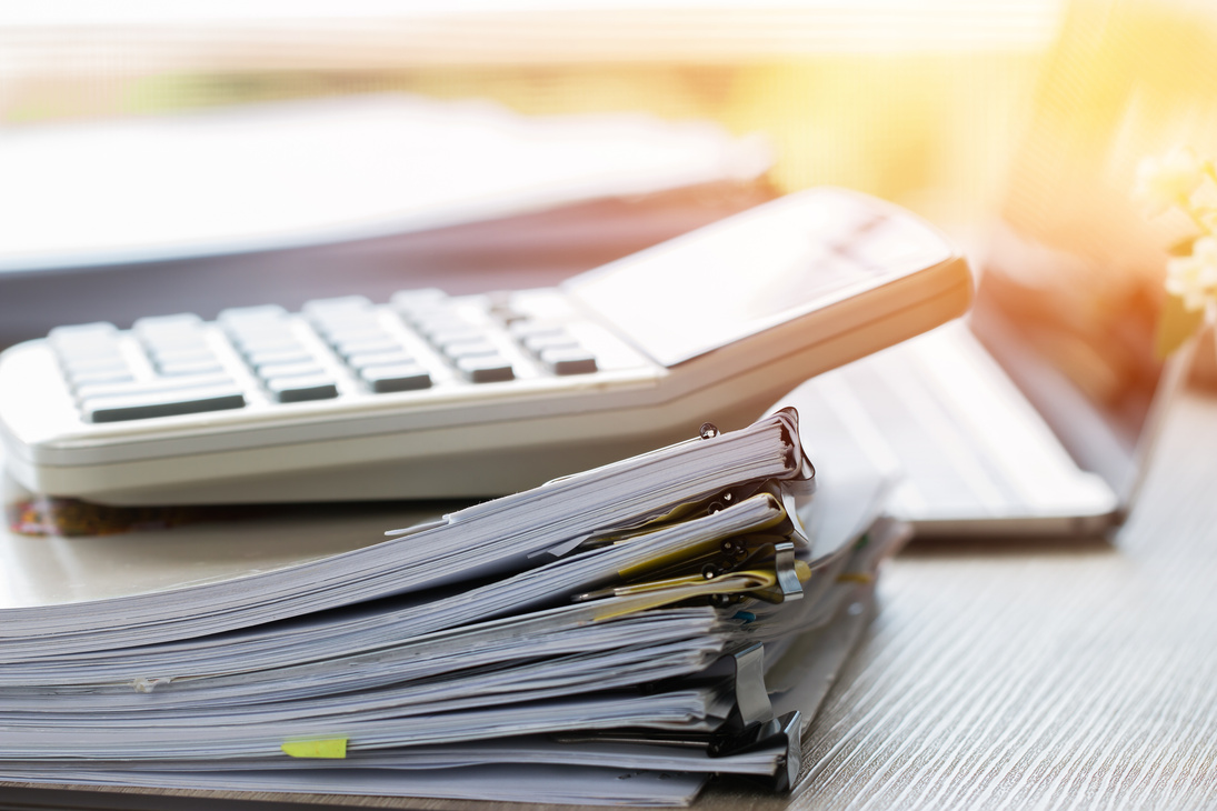 Stacks of papers documents files information business report papers, piles of unfinished document achieves with calculator laptop computer desk in modern office, Accounting planning budget concept